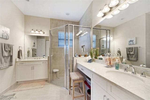 bathroom featuring vanity, tile patterned floors, and a shower with shower door