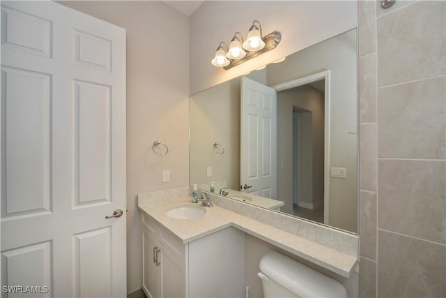 bathroom featuring vanity and toilet