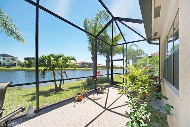 sunroom / solarium featuring a water view