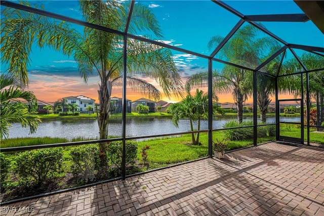 unfurnished sunroom with a water view