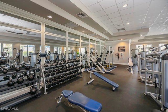 gym with ceiling fan and a drop ceiling