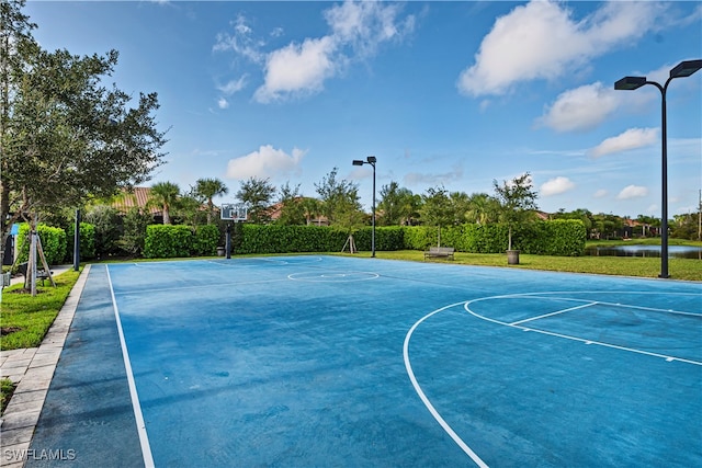 view of sport court featuring a water view