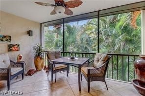 sunroom / solarium featuring ceiling fan