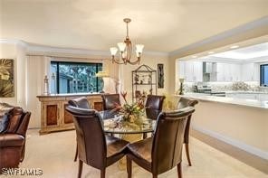 dining space featuring plenty of natural light, crown molding, and a notable chandelier