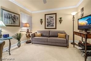 carpeted living room with a ceiling fan, crown molding, and baseboards