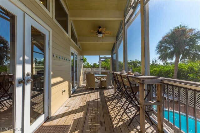 331 Spanish Gold Ln, Upper Captiva, FL 33924 - wooden deck featuring french doors, outdoor dining area, ceiling fan, and an outdoor pool