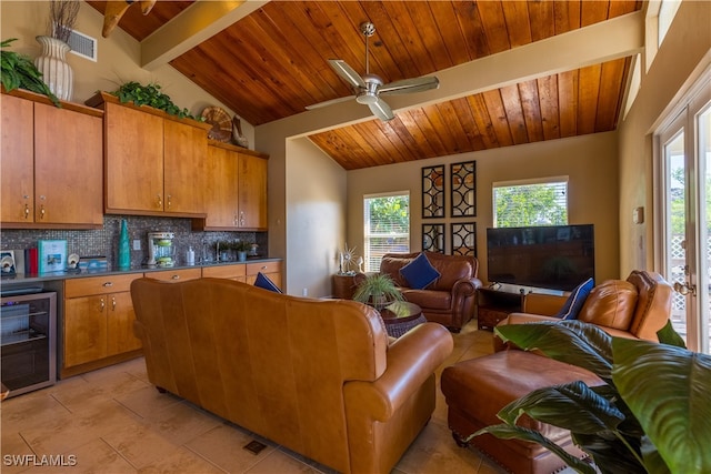 tiled living room with wooden ceiling, wine cooler, ceiling fan, and vaulted ceiling with beams