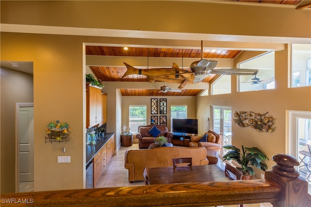 tiled dining room featuring wooden ceiling, lofted ceiling with beams, sink, and ceiling fan