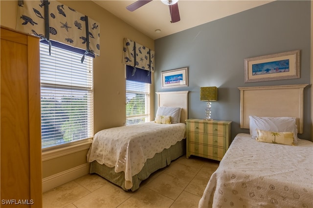 tiled bedroom featuring ceiling fan