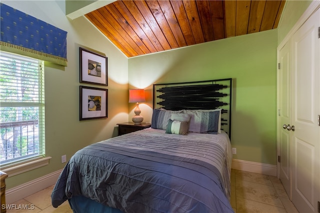 tiled bedroom featuring wooden ceiling, multiple windows, and lofted ceiling