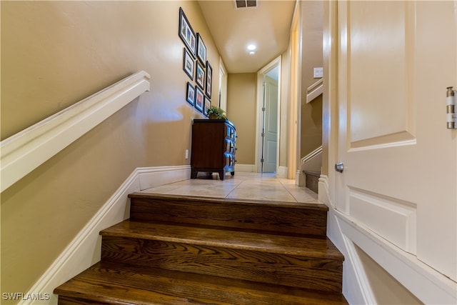 stairway featuring tile patterned floors