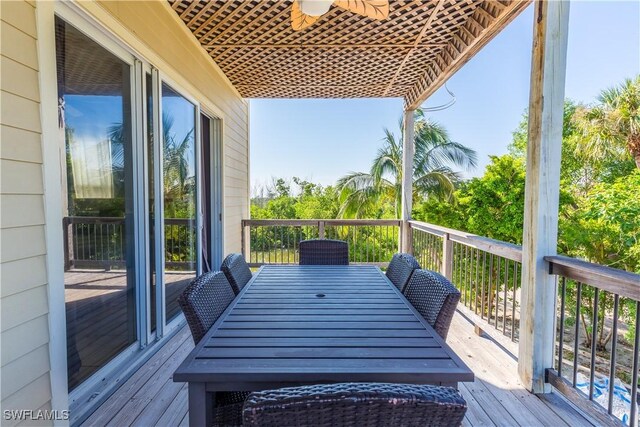 331 Spanish Gold Ln, Upper Captiva, FL 33924 - wooden terrace with outdoor dining space