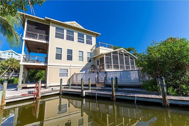 view of dock featuring a water view and a balcony