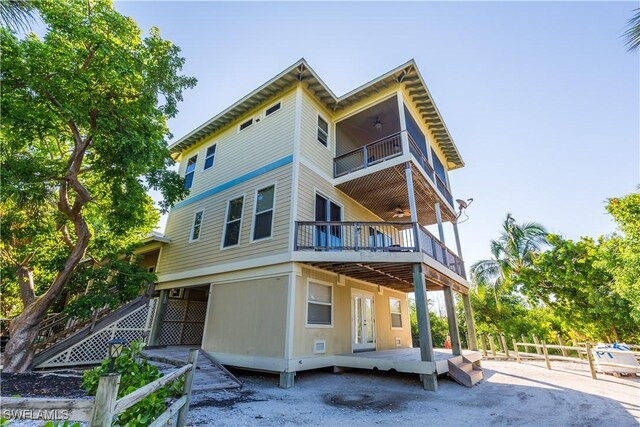331 Spanish Gold Ln, Upper Captiva, FL 33924 - rear view of house featuring a balcony, ceiling fan, fence, and french doors