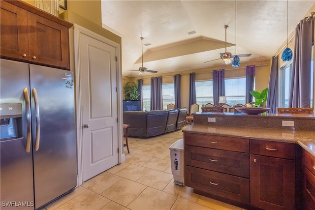 kitchen featuring stainless steel fridge with ice dispenser, light tile patterned flooring, a tray ceiling, and ceiling fan