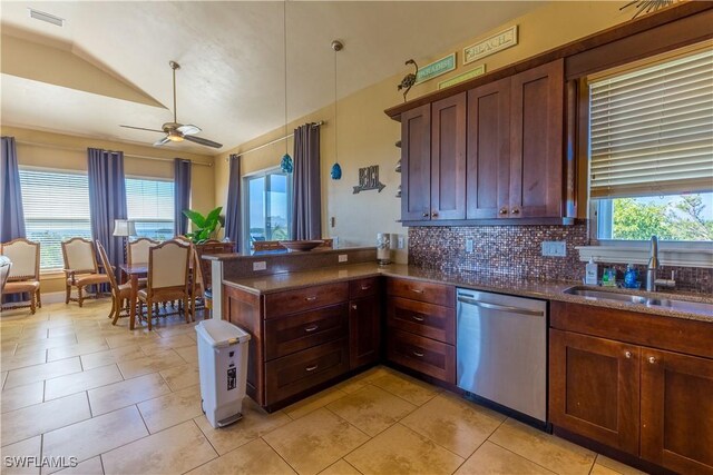 331 Spanish Gold Ln, Upper Captiva, FL 33924 - kitchen with stainless steel dishwasher, tasteful backsplash, light tile patterned flooring, a peninsula, and lofted ceiling