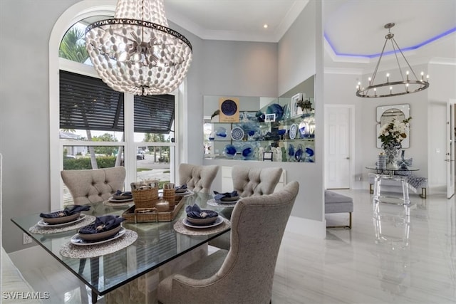 dining area featuring an inviting chandelier, a high ceiling, and crown molding