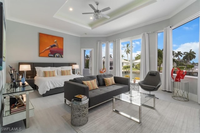 bedroom with ornamental molding, a raised ceiling, light hardwood / wood-style floors, and ceiling fan