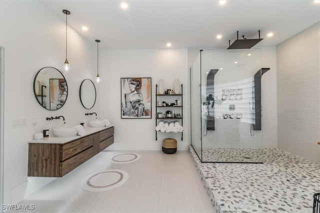 bathroom featuring vanity and a tile shower