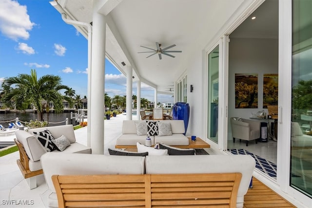 view of patio with ceiling fan, a water view, and an outdoor hangout area