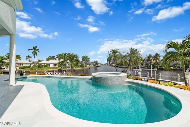 view of swimming pool featuring a water view, an in ground hot tub, and a patio area