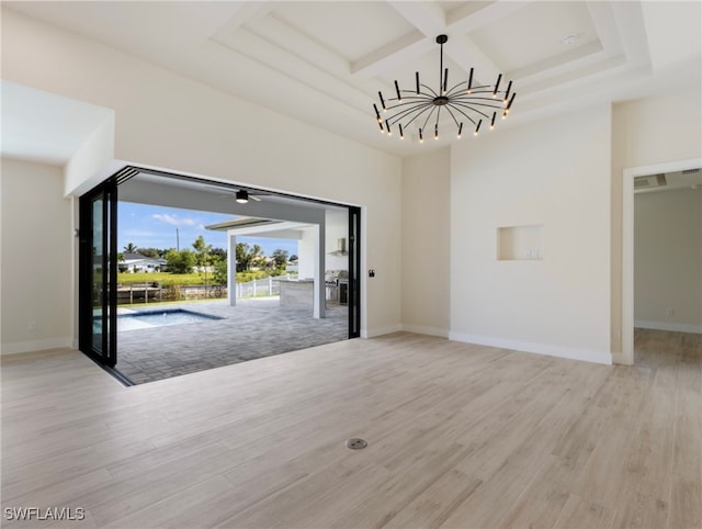 interior space featuring coffered ceiling, a chandelier, and light hardwood / wood-style floors