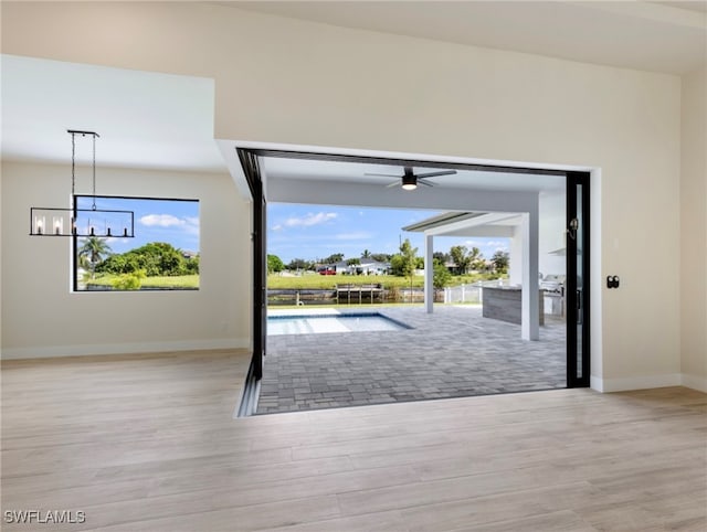 doorway to outside featuring light hardwood / wood-style floors and ceiling fan