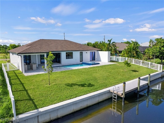 rear view of property with a fenced in pool, a patio area, a yard, and a water view