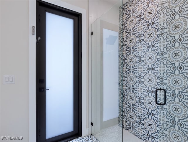 bathroom with a shower with door