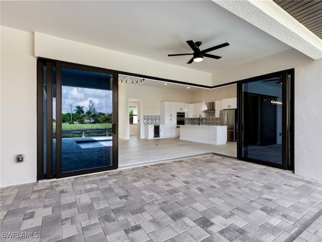 interior space with ceiling fan