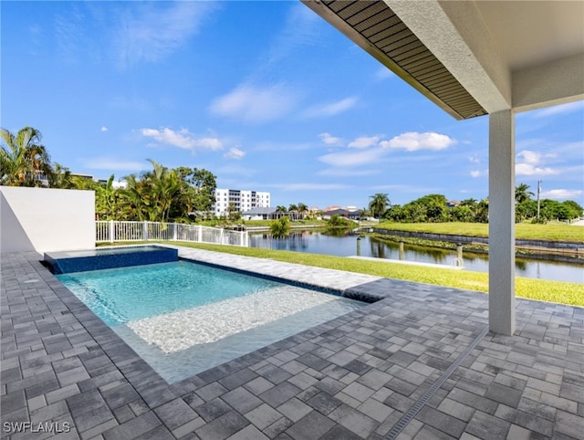 view of pool with a patio and a water view