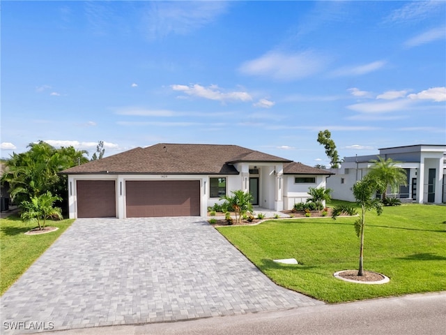 view of front of house featuring a garage and a front yard