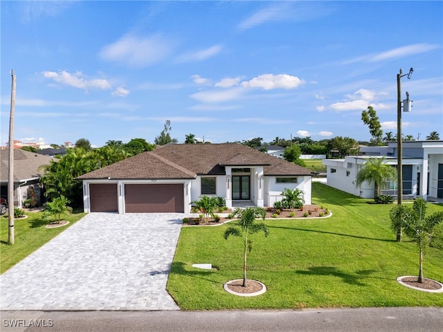 view of front of house featuring a front yard and a garage