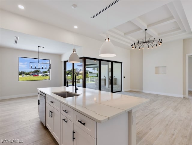 kitchen featuring white cabinetry, pendant lighting, light stone countertops, and stainless steel dishwasher