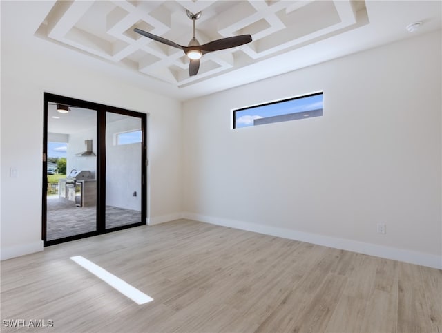 spare room with light hardwood / wood-style floors, beam ceiling, ceiling fan, and coffered ceiling