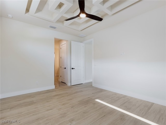 spare room featuring coffered ceiling, beam ceiling, ceiling fan, and light hardwood / wood-style flooring