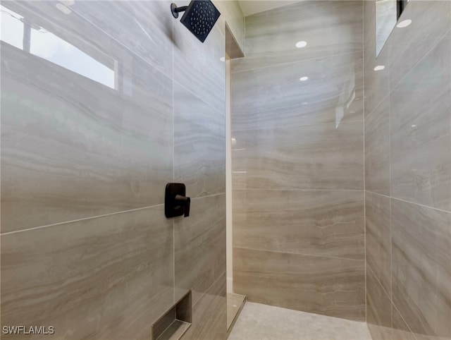 bathroom with a tile shower