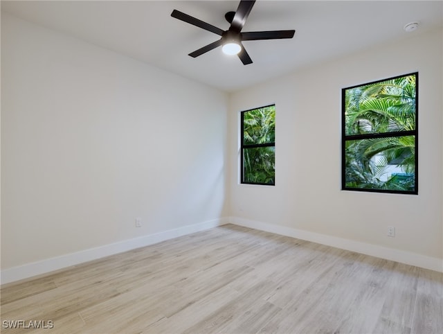 spare room featuring ceiling fan and light hardwood / wood-style flooring