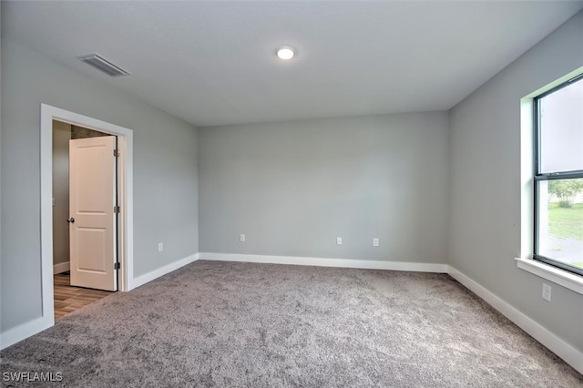 unfurnished room featuring carpet flooring