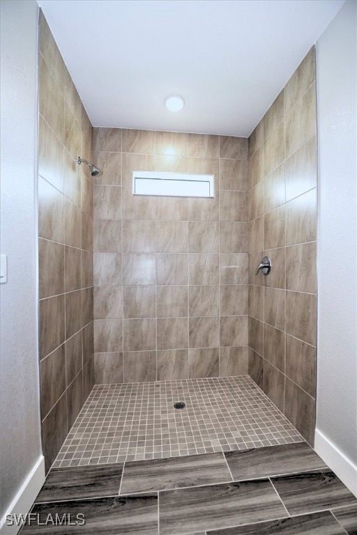 bathroom with a tile shower