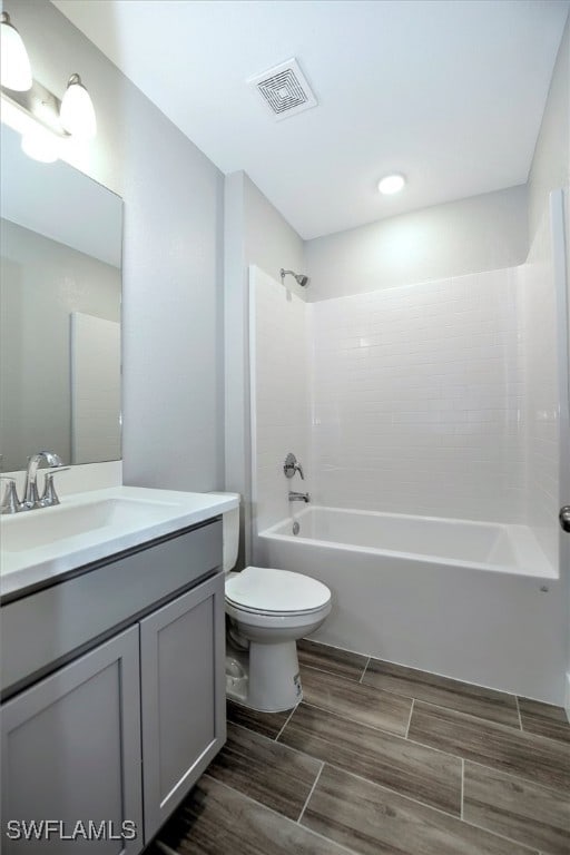 full bathroom with toilet, vanity, and tub / shower combination