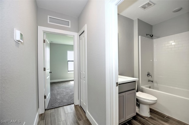 full bathroom featuring vanity, toilet, and  shower combination