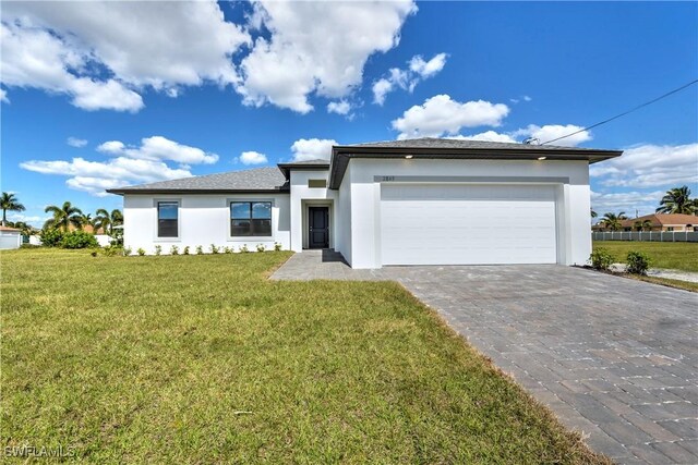 view of front facade with a front lawn and a garage