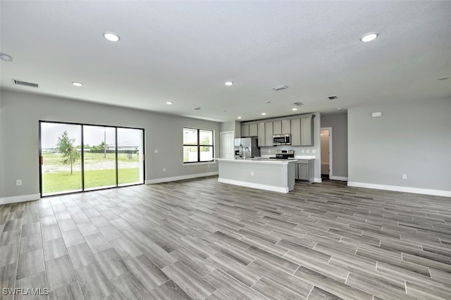 unfurnished living room featuring light wood-type flooring