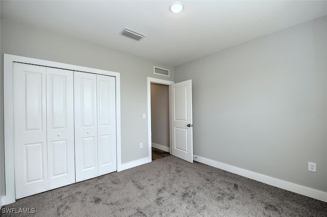 unfurnished bedroom featuring carpet and a closet