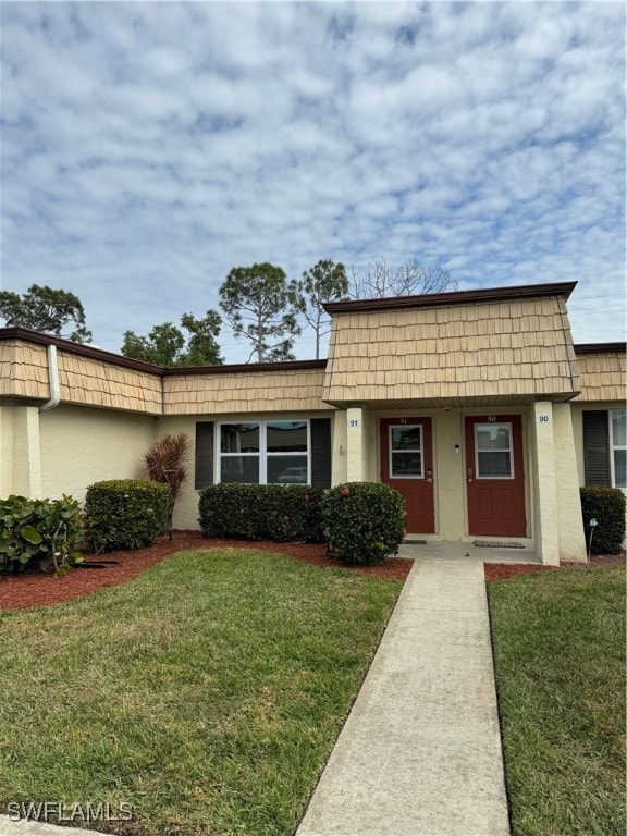 ranch-style home with a front lawn