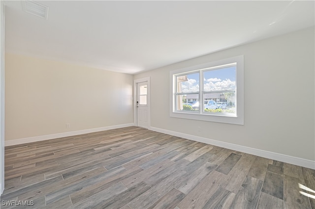 empty room with hardwood / wood-style floors