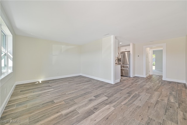 unfurnished living room with light wood-type flooring