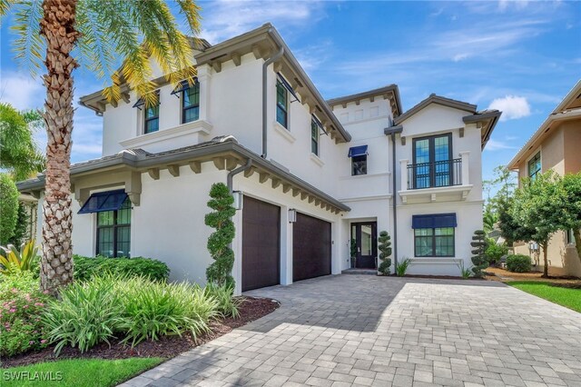 14690 Reserve Pl, Naples, FL 34109 - italianate house with a garage, a balcony, and stucco siding