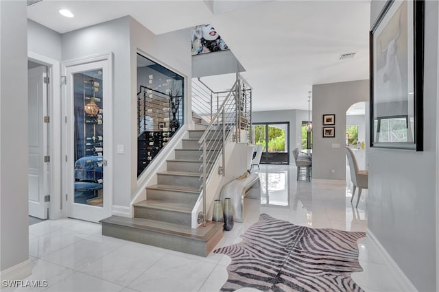 14690 Reserve Pl, Naples, FL 34109 - stairway with arched walkways and baseboards